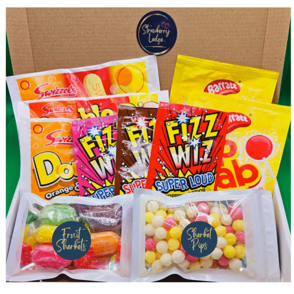 Srawberry Ledge Letterbox sweets gift Box, top middle strawberry ledge blue and gold circular logo. Underneath from the left are 3 red, orange and yellow packs of swizzels double dips, to the right are 3 packs of fizz wizz popping cnady in raspberry, cola and strawberry. to the left are 2 packs of Barratts Double dips in a yellow and red pack. Underneath to the left is a 50g pack of Fruit sherbet sweets, to the left if a 50g pack of Sherbet pips.